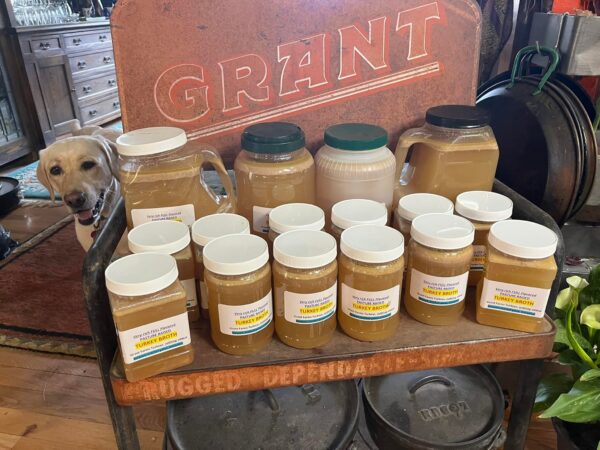 a stand stocked full of our homemade turkey broth up for sale
